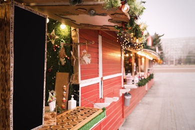 Bright Christmas fair stalls with decor outdoors