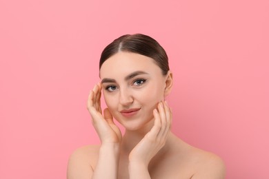 Photo of Makeup product. Woman with black eyeliner and beautiful eyebrows on pink background