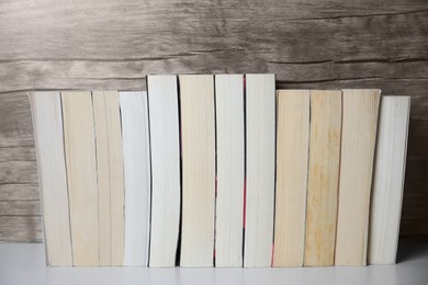 Collection of different books on white shelf