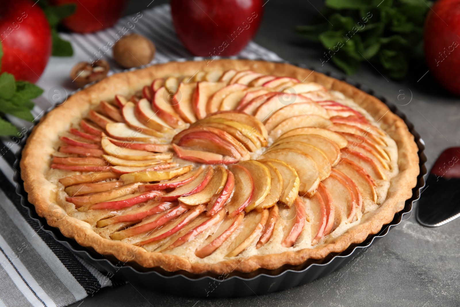 Photo of Delicious homemade apple tart on grey table