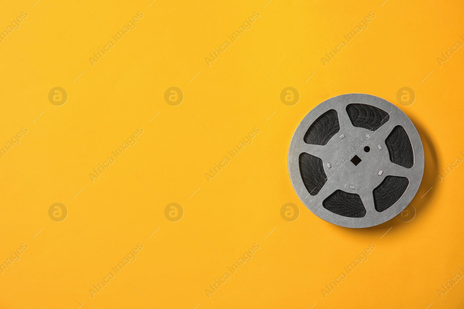 Photo of Movie reel on color background, top view with space for text. Cinema production