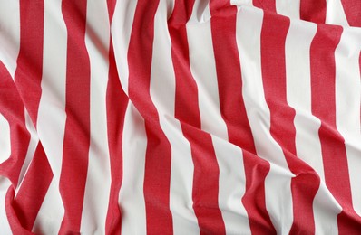 Crumpled striped beach towel as background, top view