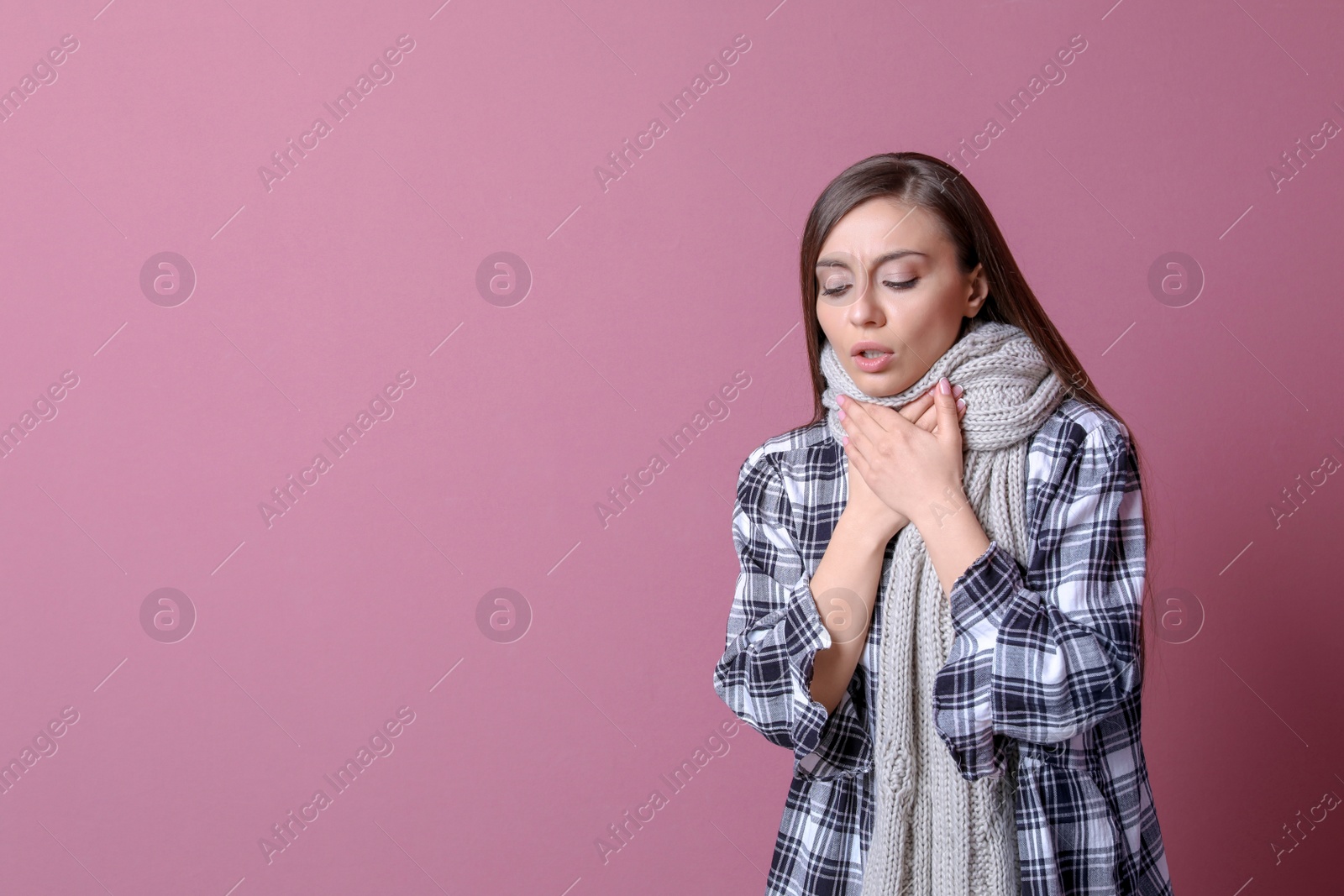 Photo of Young woman coughing on color background