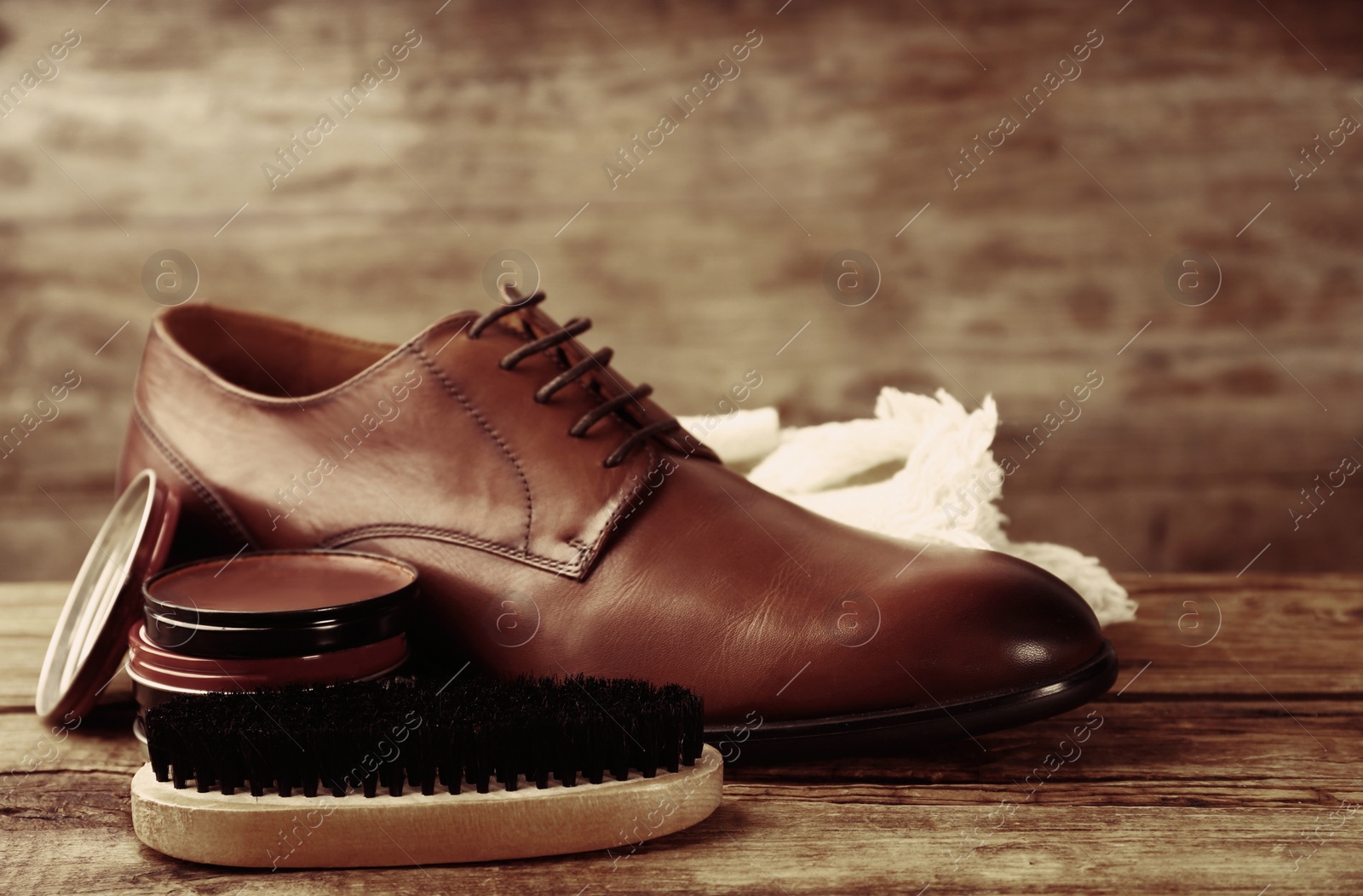 Image of Footwear care accessories and shoe on wooden background