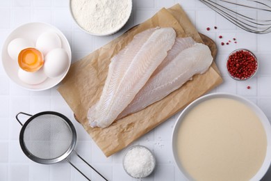 Photo of Different ingredients for batter and raw fish fillet on white tiled table, flat lay