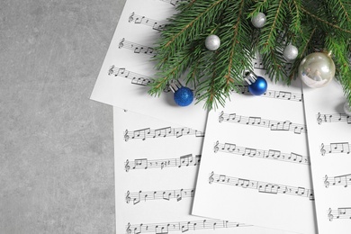 Flat lay composition with Christmas decorations and music sheets on table. Space for text