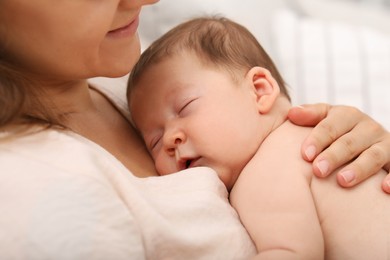 Photo of Mother holding her cute newborn baby indoors