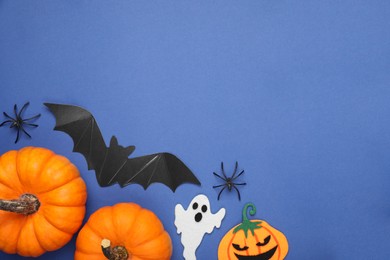 Photo of Flat lay composition with Halloween decor on blue background, space for text