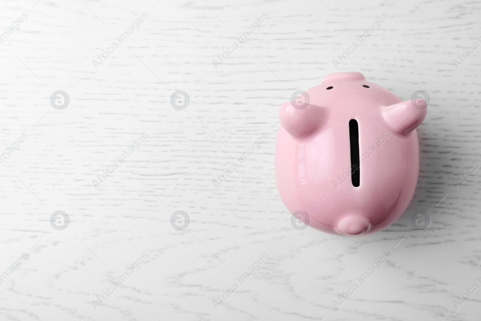 Photo of Pink piggy bank on table, top view