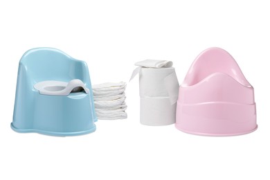 Image of Light blue and pink baby potties, toilet paper and diapers isolated on white