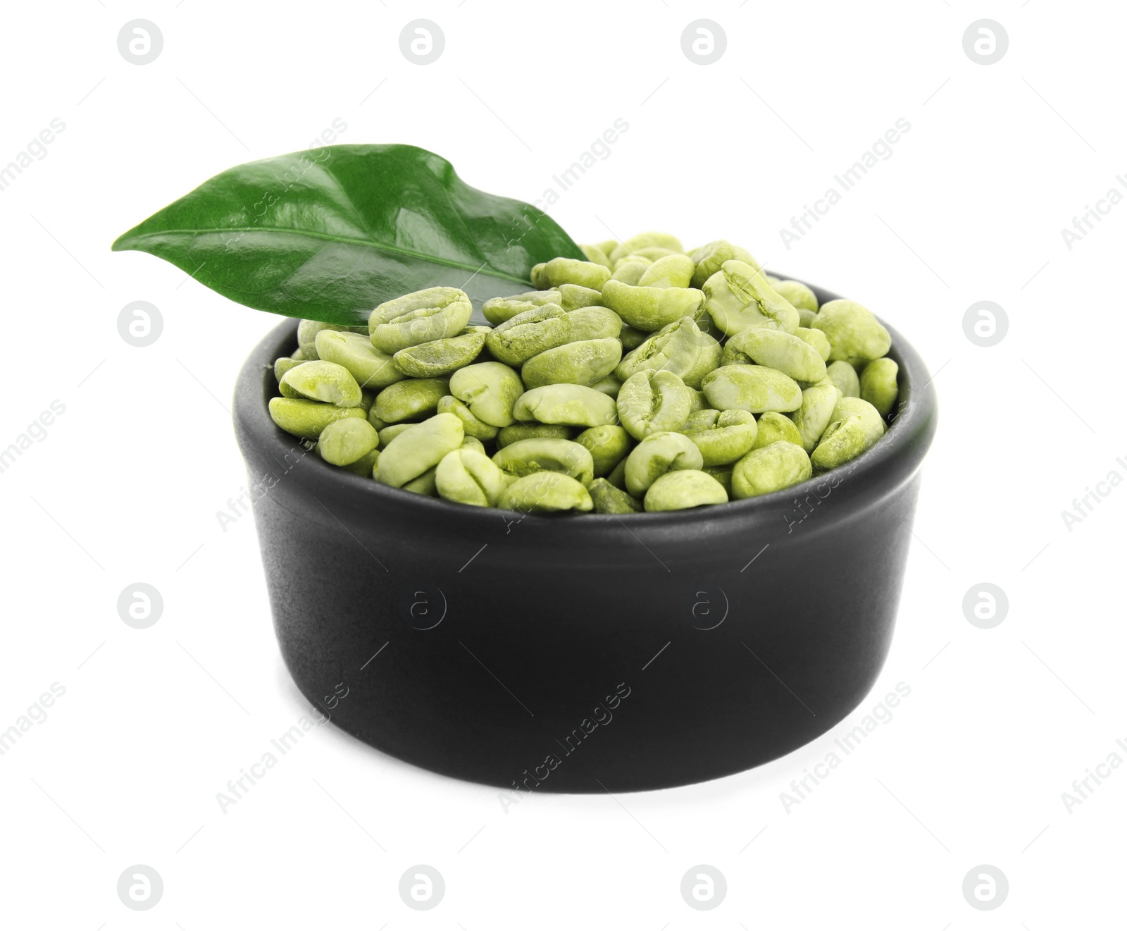 Photo of Bowl with green coffee beans and fresh leaf on white background