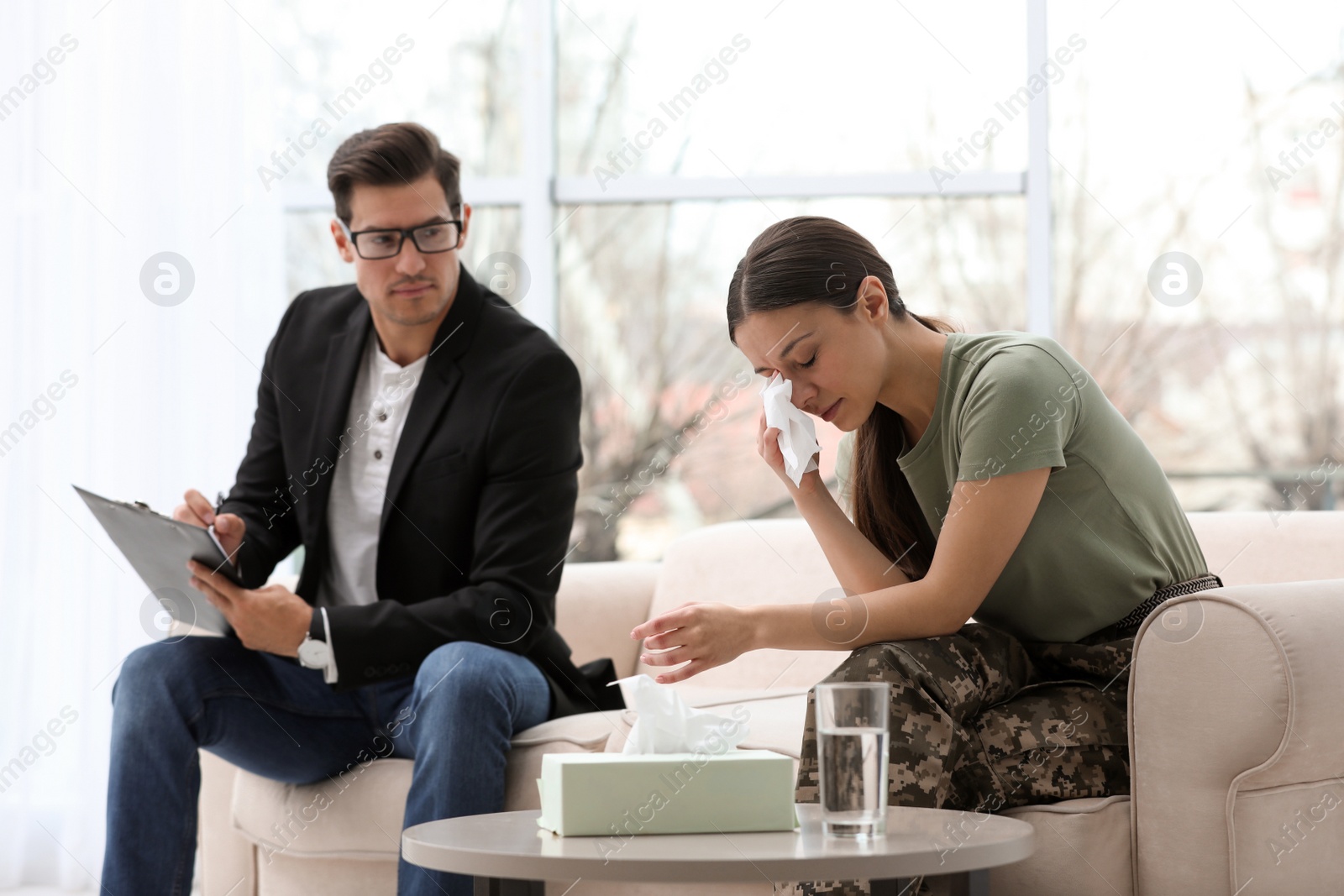 Photo of Psychotherapist working with female military officer in office