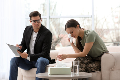 Photo of Psychotherapist working with female military officer in office