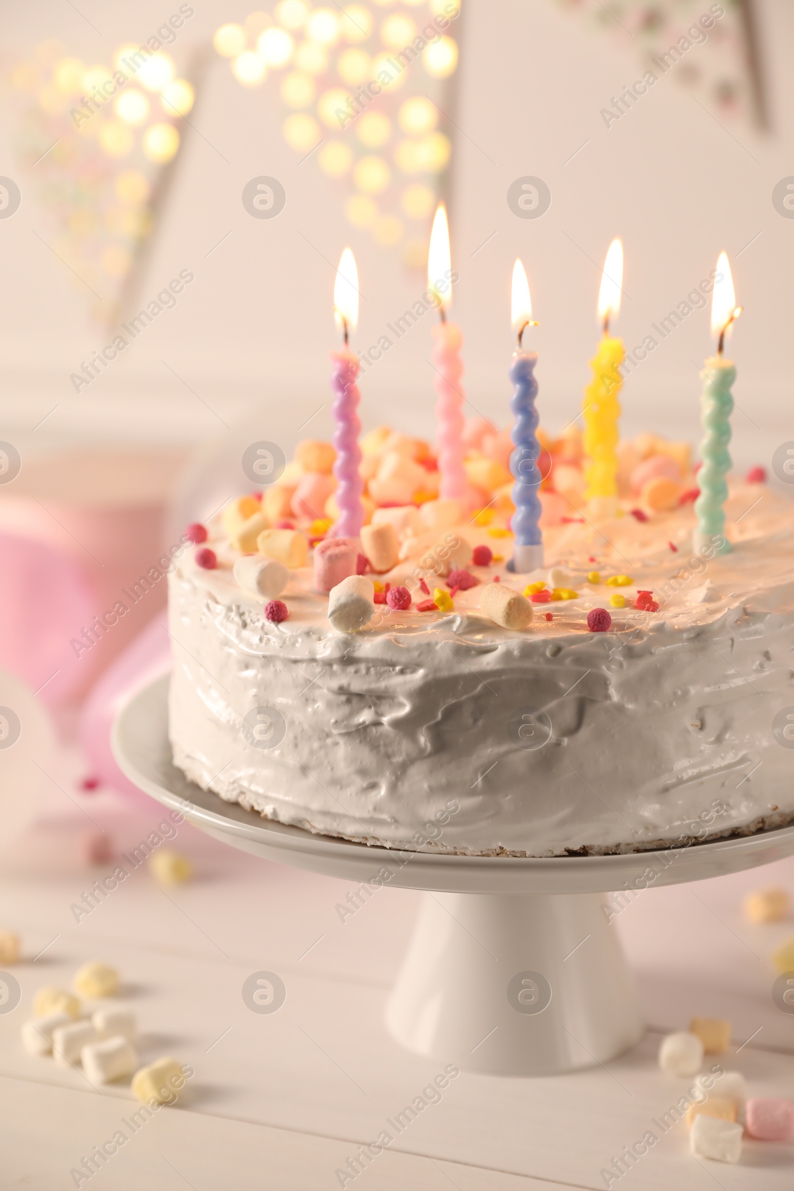 Photo of Tasty Birthday cake with burning candles on white table, closeup