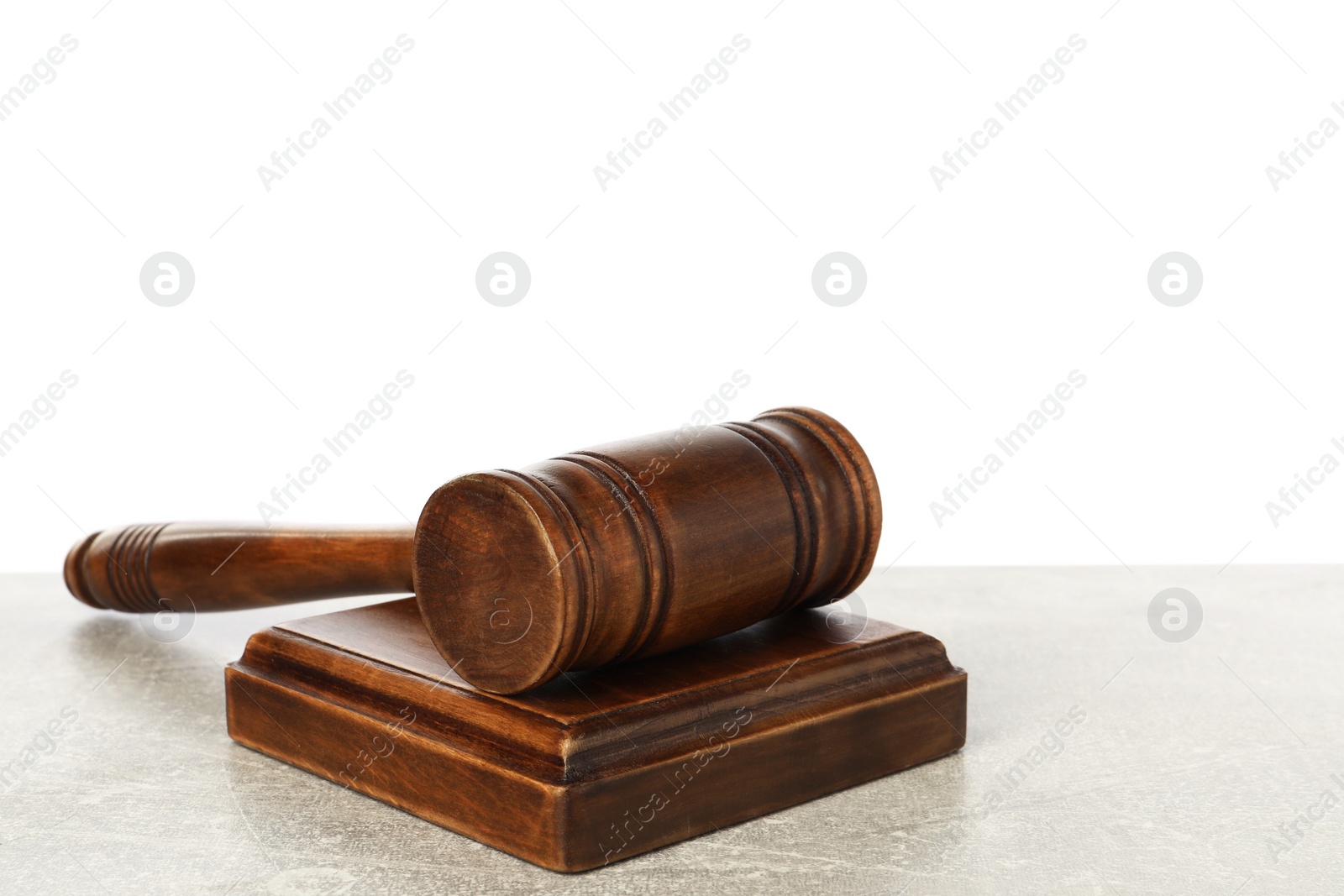 Photo of Wooden gavel on light table against white background. Space for text