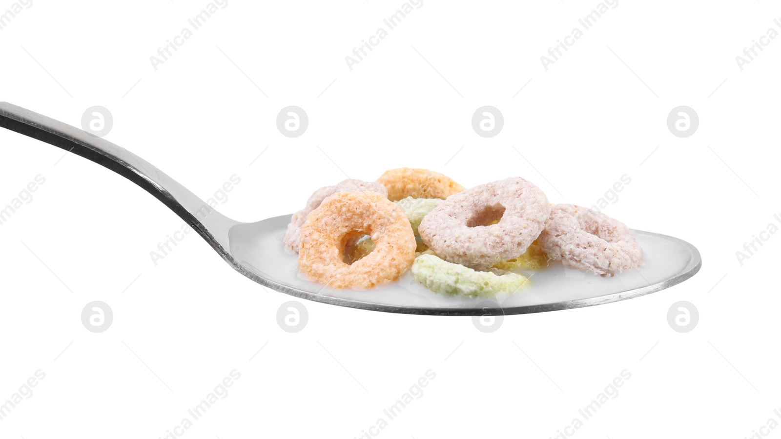 Photo of Cereal rings and milk in spoon isolated on white