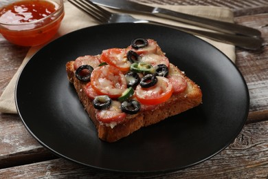 Tasty pizza toast, sauce and cutlery on wooden table, closeup