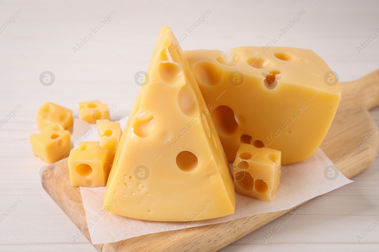 Photo of Tasty fresh cheese on white wooden table, closeup