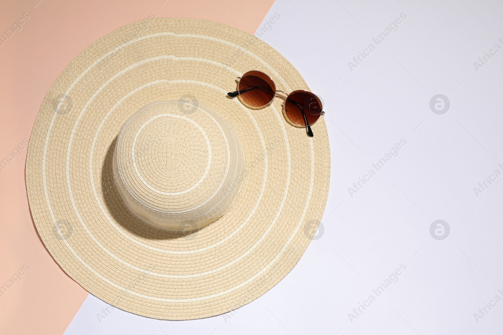 Photo of Stylish hat and sunglasses on color background, top view. Beach objects