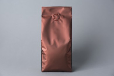 Photo of One blank foil package on grey background