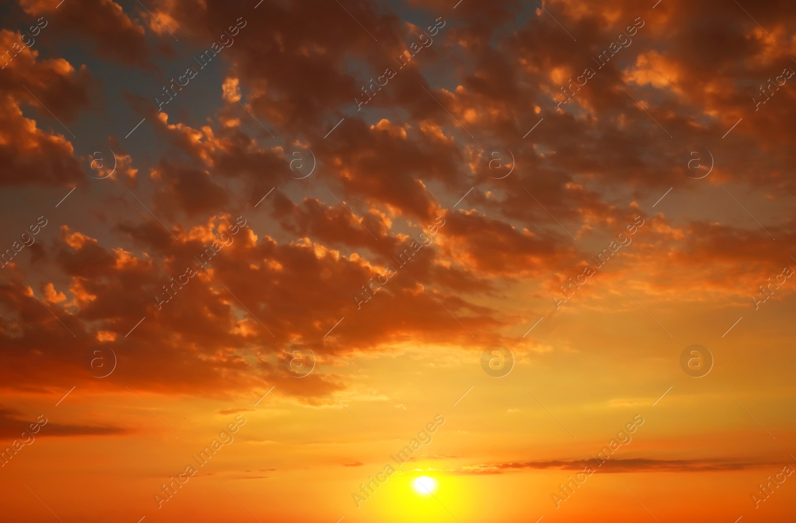 Image of Beautiful view of orange sky with clouds at sunset