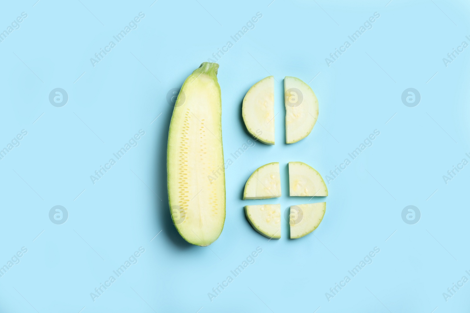 Photo of Fresh ripe green zucchini on light blue background, flat lay