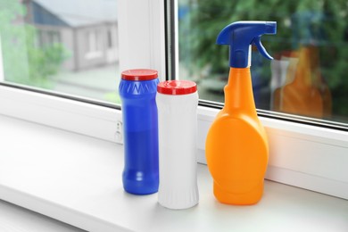 Photo of Different bottles of cleaning products on windowsill