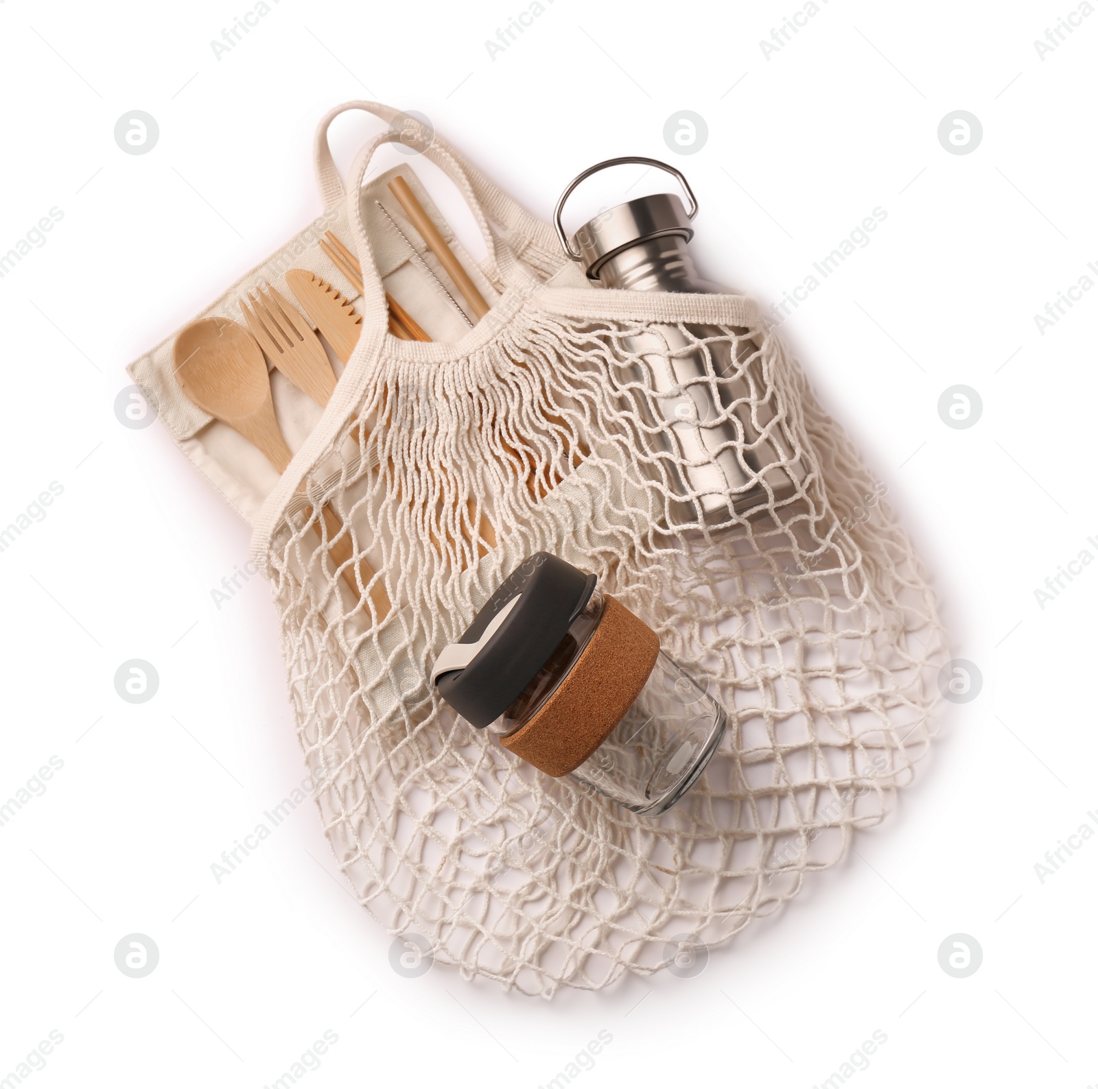 Photo of Fishnet bag with different items isolated on white, top view. Conscious consumption