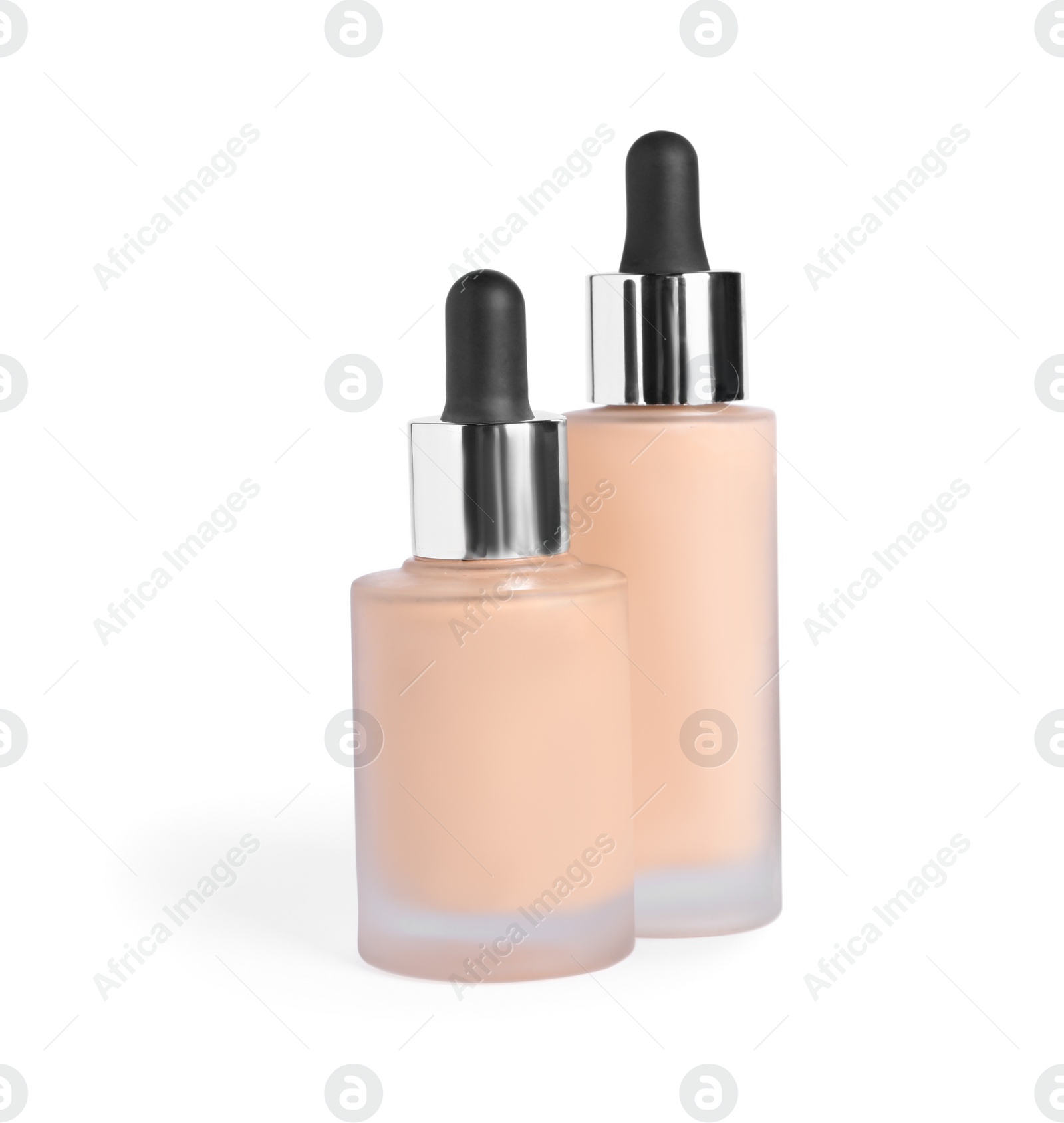 Photo of Bottles of skin foundation on white background. Makeup product