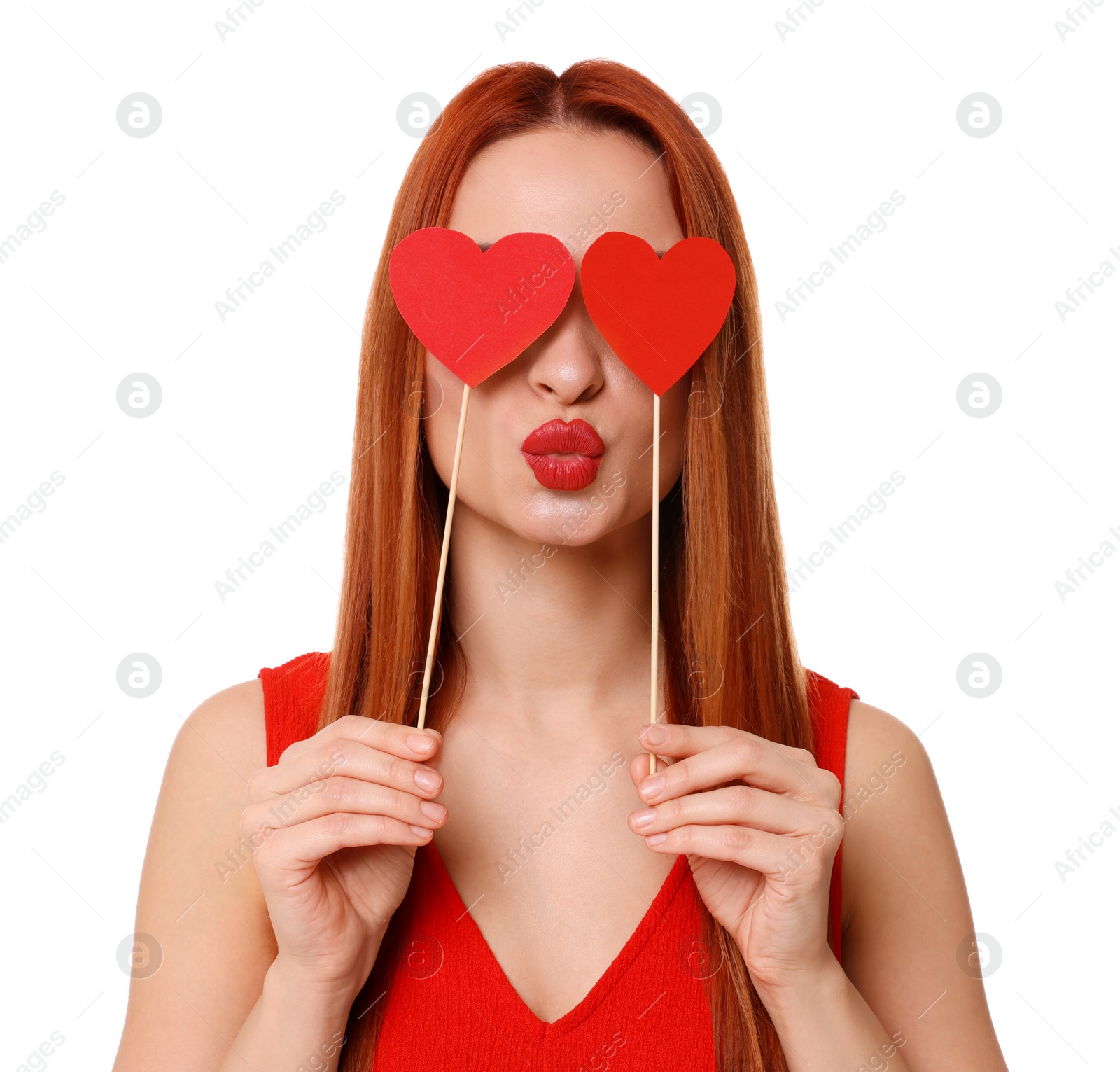 Photo of Young woman in red dress covering her eyes with paper hearts on white background