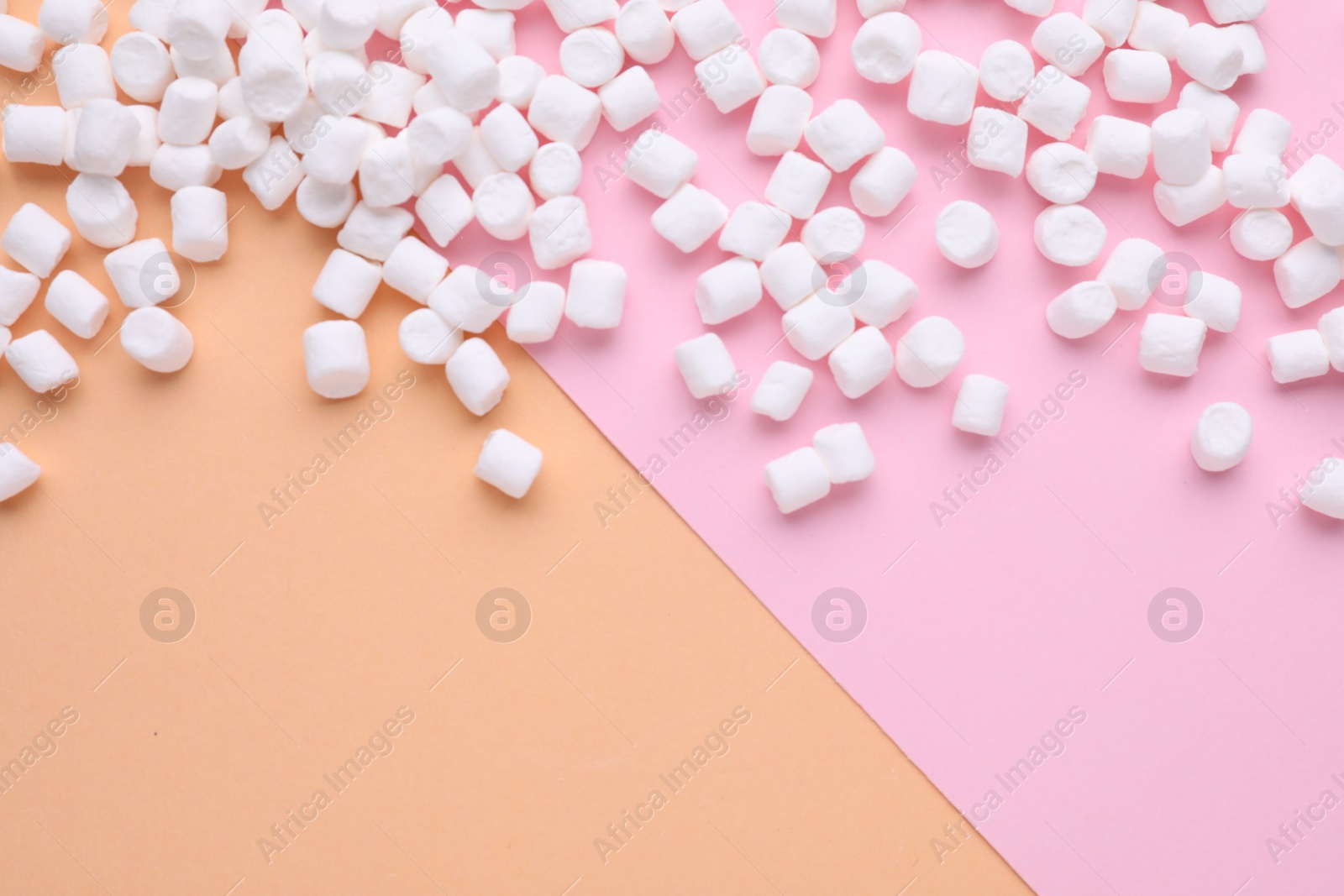 Photo of Delicious marshmallows on color background, flat lay. Space for text