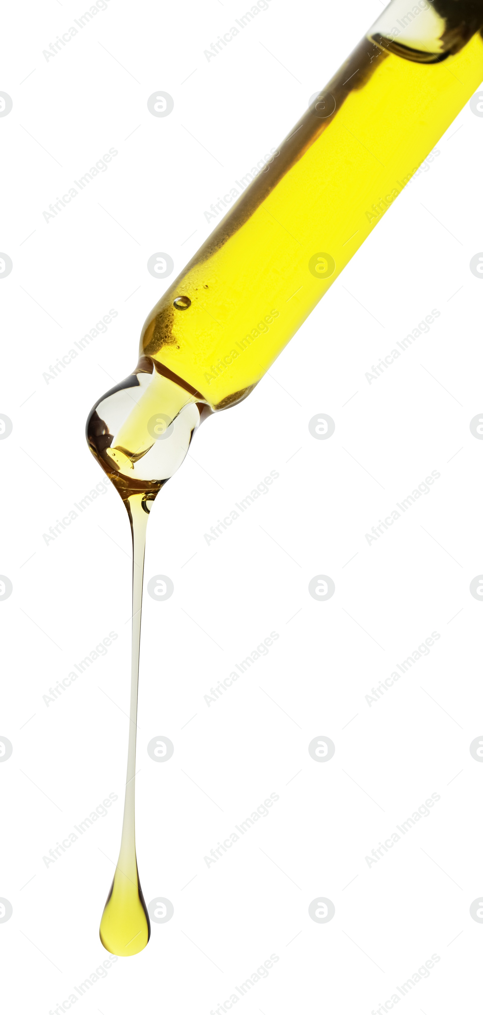 Photo of Dripping yellow facial serum from pipette on white background, closeup