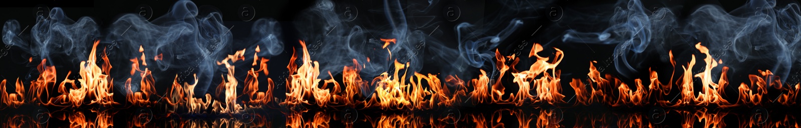 Image of Bright fire flames with smoke on black background. Banner design
