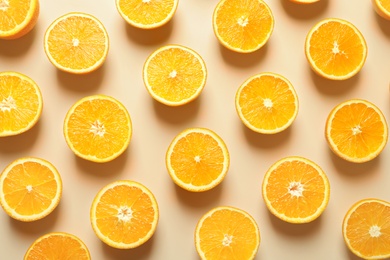 Flat lay composition with ripe oranges on color background