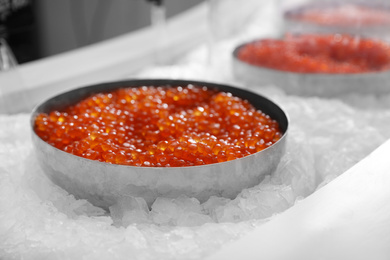 Photo of Delicious red caviar on ice. Wholesale market
