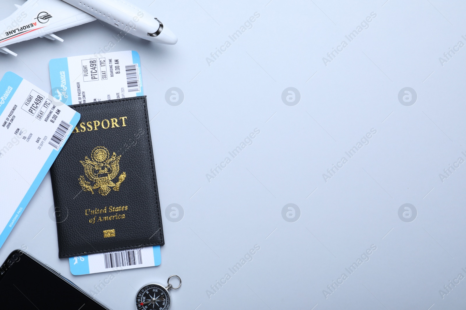 Photo of Flat lay composition with tickets and passport on white background, space for text. Travel agency concept