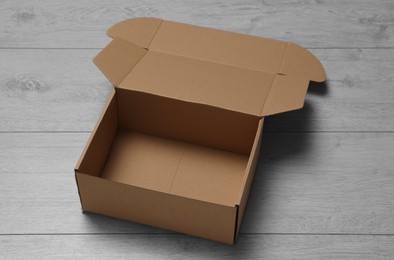 Photo of One empty open cardboard box on floor