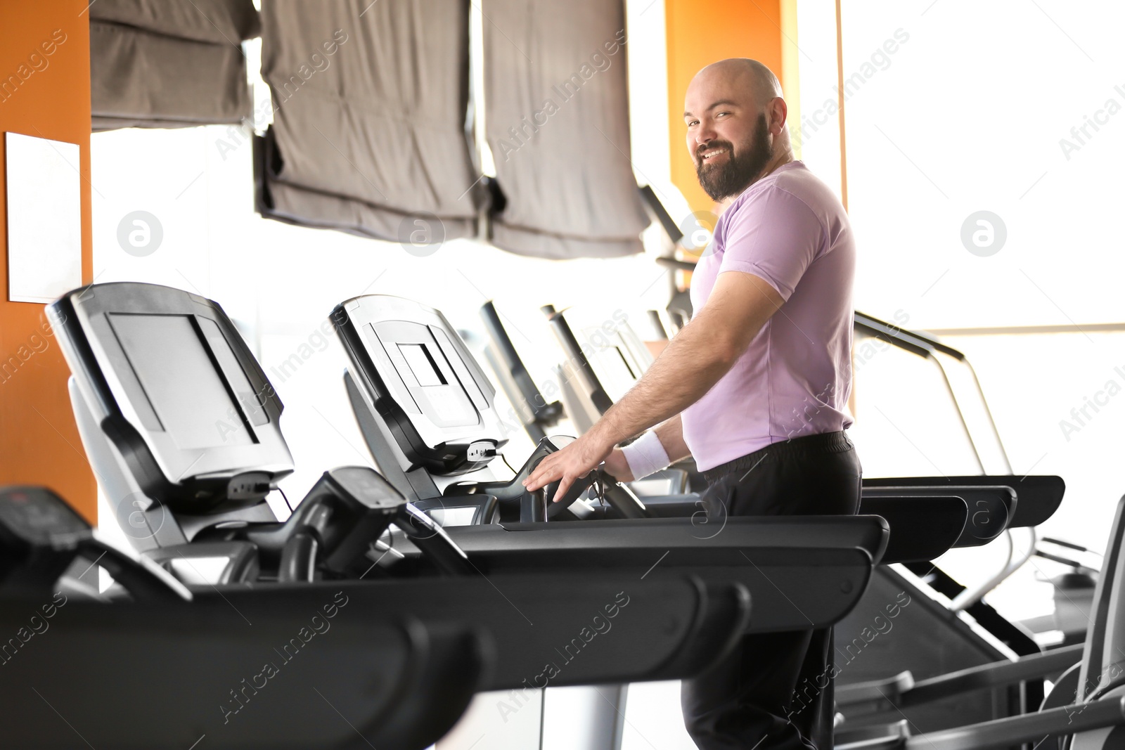 Photo of Overweight man training in gym