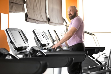 Overweight man training in gym