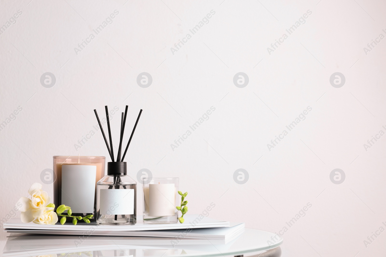 Photo of Composition with aromatic reed air freshener on white table, space for text