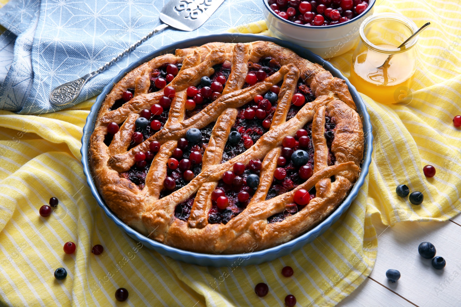 Photo of Delicious currant pie and fresh berries on white wooden table