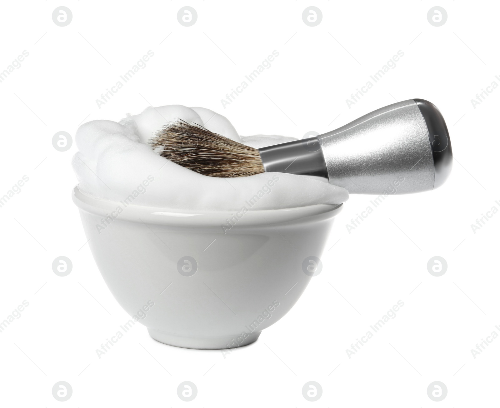 Photo of Shaving brush for men and bowl with foam on white background