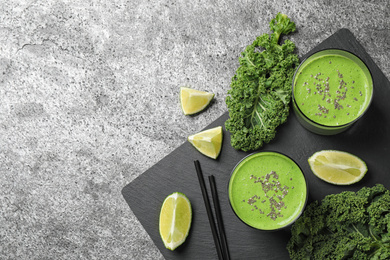 Photo of Flat lay composition with tasty kale smoothie on grey table