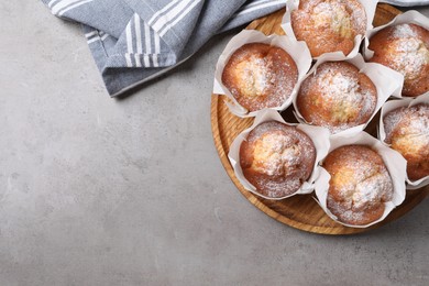 Photo of Delicious muffins on grey table, top view. space for text