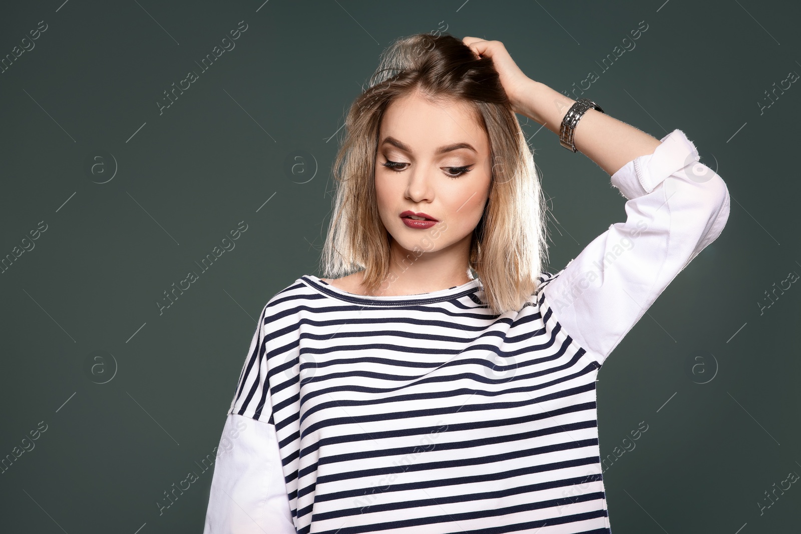 Photo of Beautiful young woman posing on color background