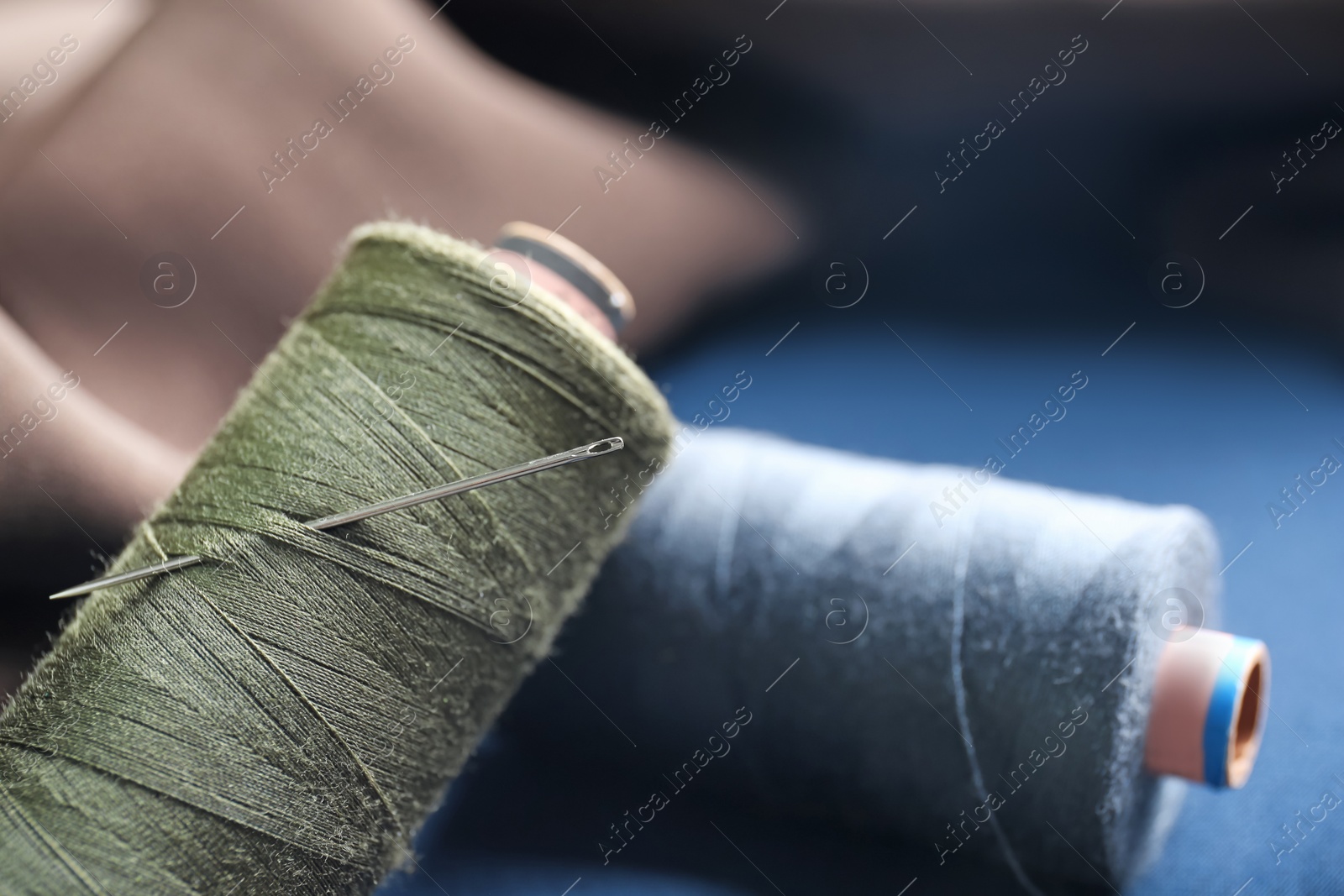 Photo of Threads with needle for tailoring, closeup