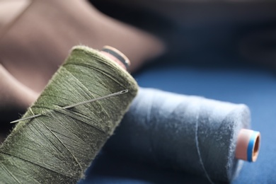 Threads with needle for tailoring, closeup