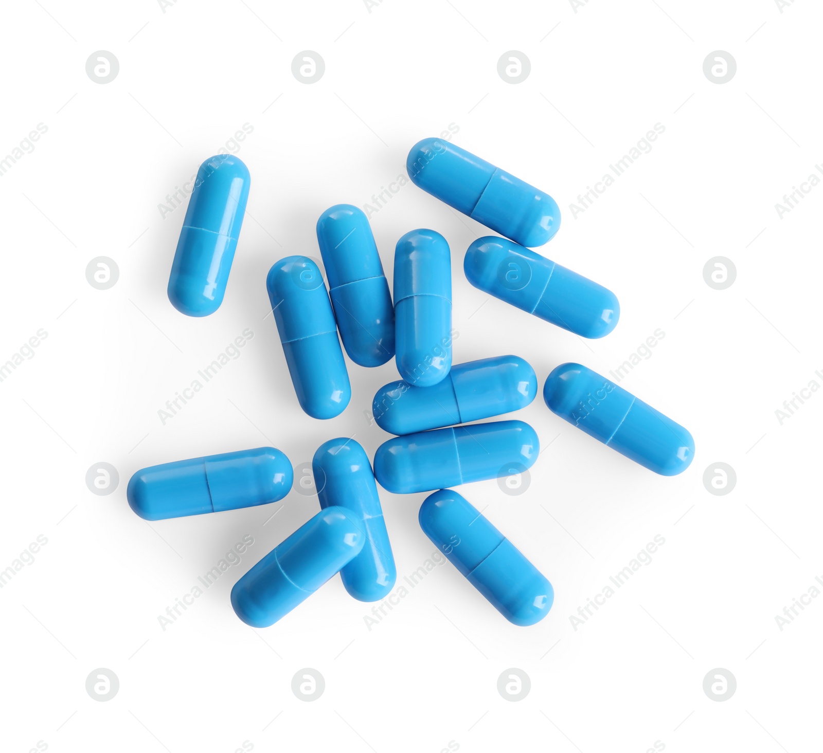 Photo of Many light blue pills isolated on white, top view