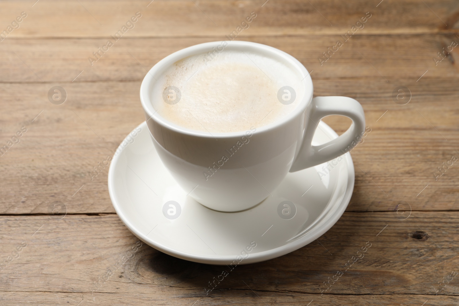 Photo of Cup of aromatic coffee on wooden table