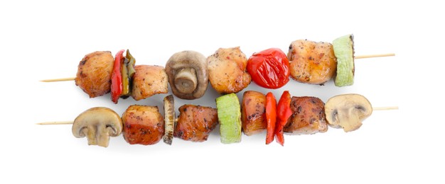 Delicious shish kebabs with mushrooms, tomato and zucchini isolated on white, top view
